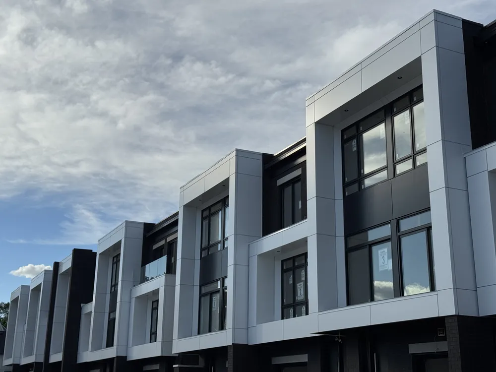 Modern townhome row with grey ACP panels